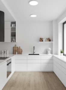 آشپزخانه کوچک با کابینت سفید و نورپردازی مخفی زیر کابینت